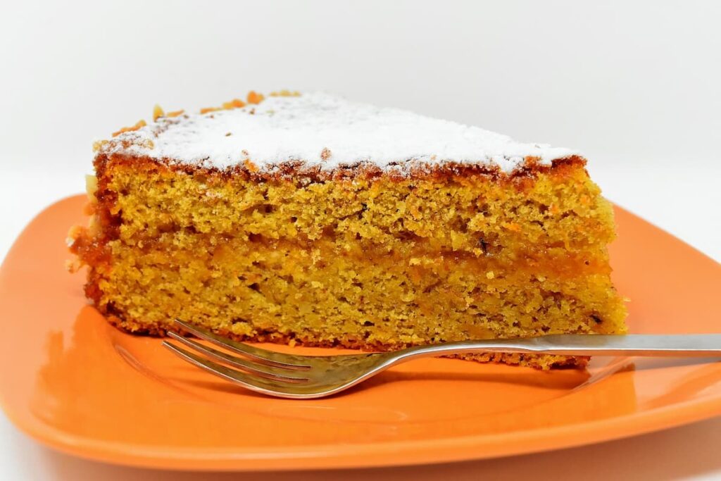 Imagem mostra um belo pedaço de bolo de cenoura zero lactose.