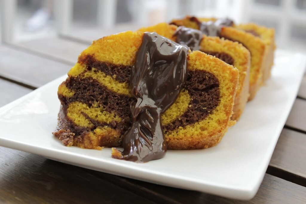 Imagem mostra pedaços irresistíveis de bolo de cenoura com chocolate.